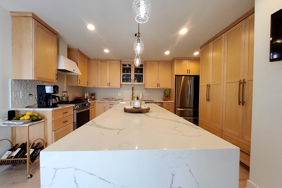 After: designer maple kitchen with Calacatta quartz waterfall island