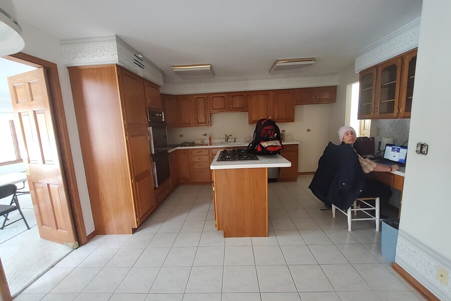 Before: 1990s cherry kitchen with dated cabinets