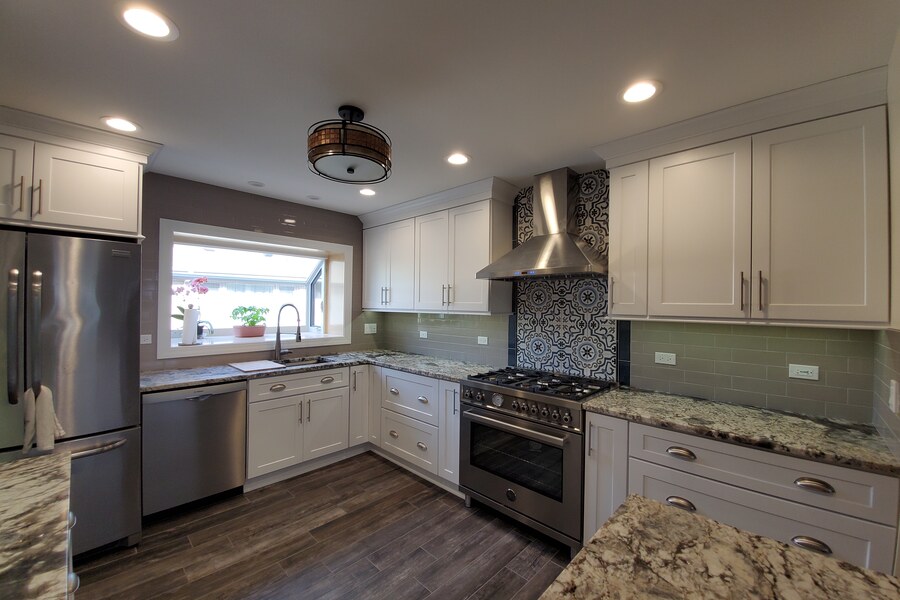 After: bright white shaker kitchen with subway tile and granite