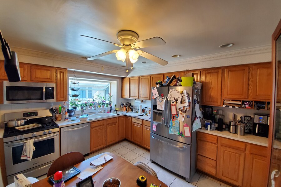 Before: dated oak kitchen with popcorn ceiling and brass fixtures